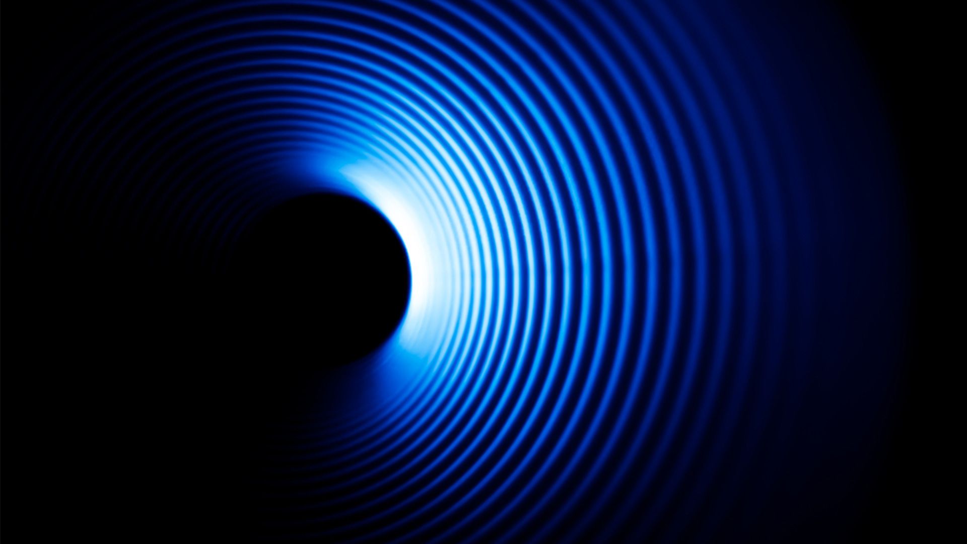 Blau-weiße Tonwellen auf schwarzem Hintergrund.