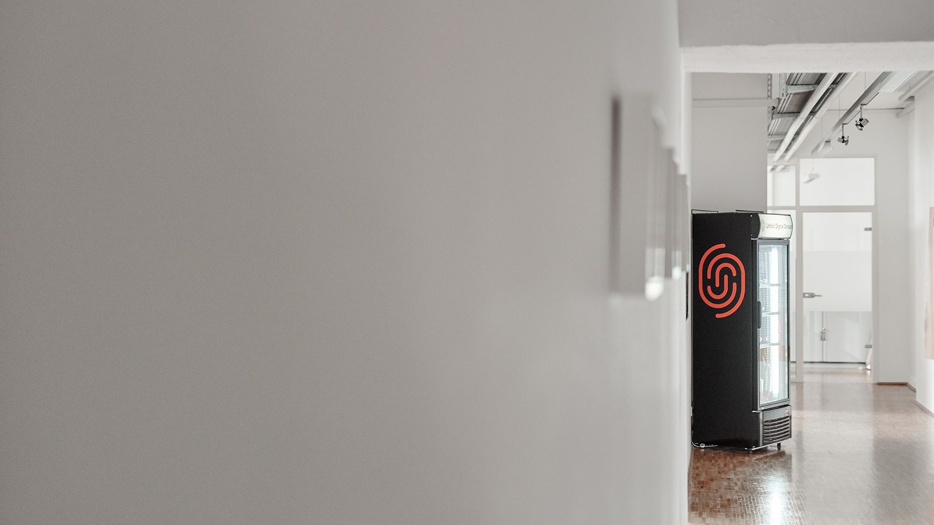 corridor with vending machine and UDG logo
