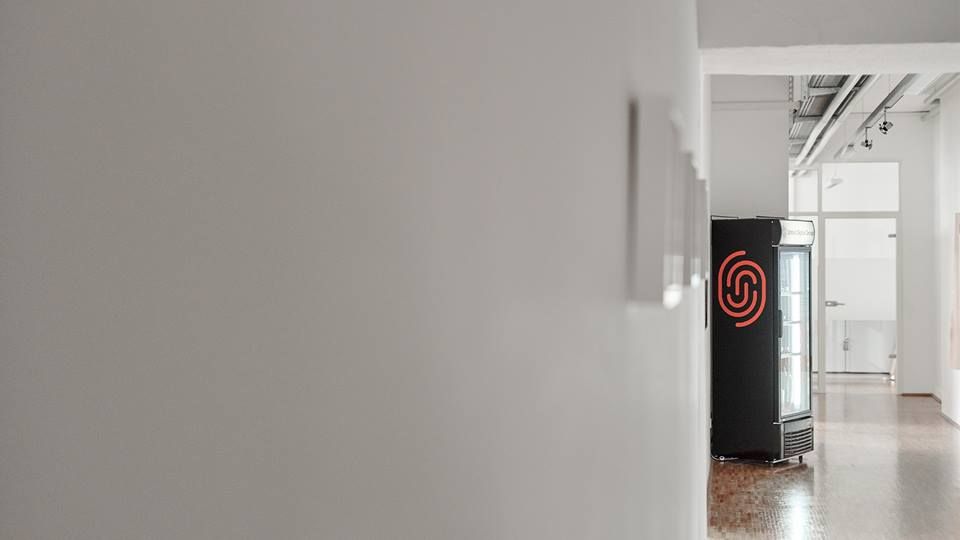 corridor with vending machine and UDG logo